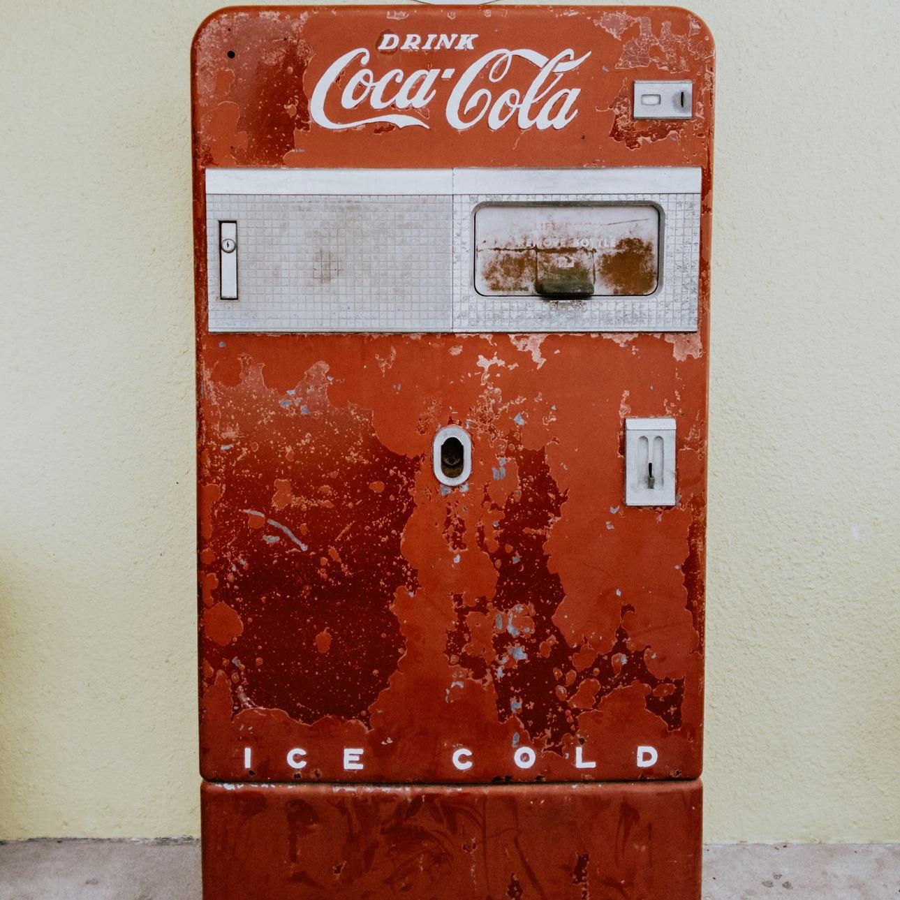 Coca-Cola refrigerator beside wall